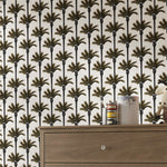 Wallpaper with palm tree pattern and a wooden dresser in the foreground.