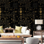 Living room with decorative wall featuring astrological symbols and text.