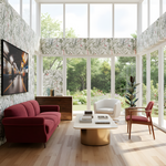Modern living room with red sofa, white armchair, and gold coffee table in a bright room with large windows.