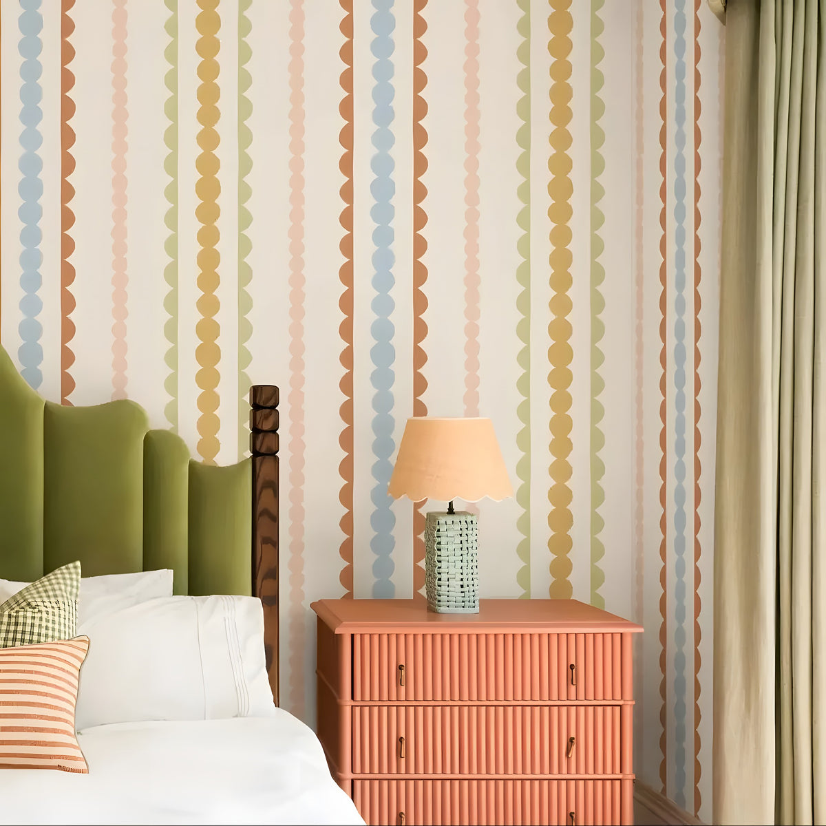 Bedroom with colorful striped wallpaper, green headboard, and pink nightstand.