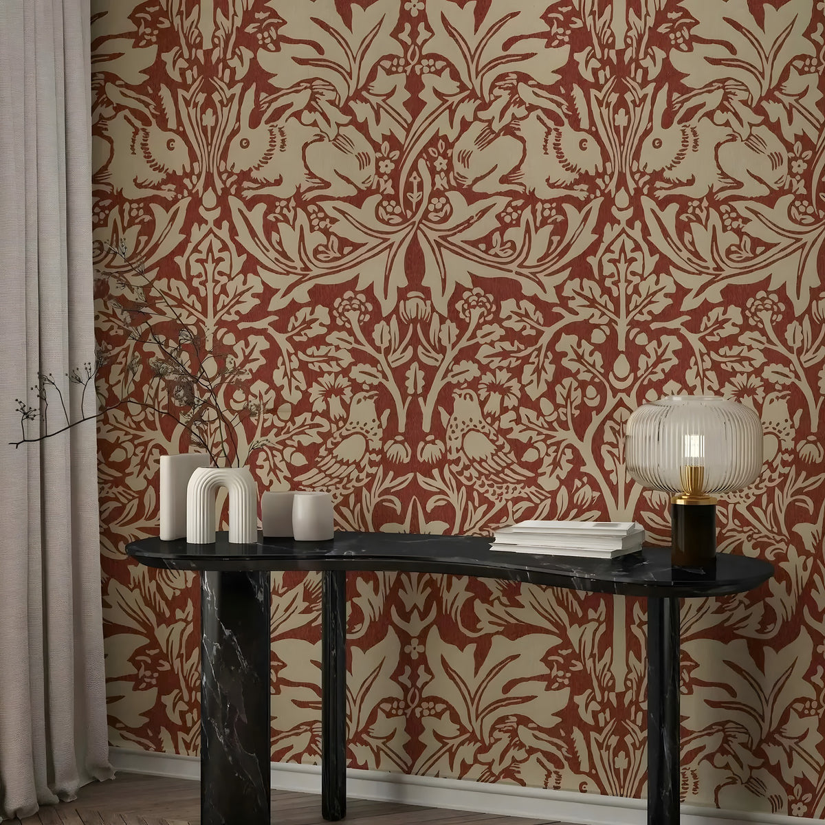 Decorative wall with intricate red and beige pattern, table with decorative items against the wall.