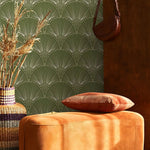 Decorative pillow on a textured surface with a patterned wall in the background