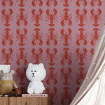 White teddy bear on a wooden shelf against a pink wall with red lobster pattern