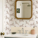 Bathroom with patterned wallpaper, mirror, sink, and decorative elements.