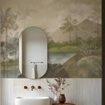 Bathroom with oval mirror, sink, and decorative elements against a tropical-themed wallpaper.