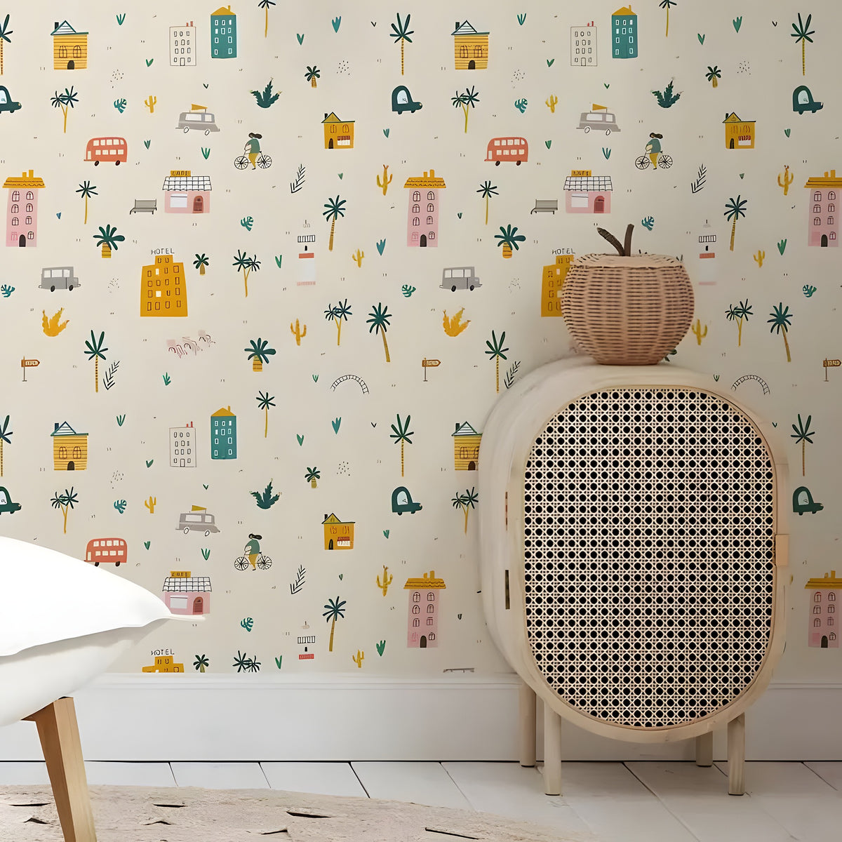 Wicker chair with patterned wallpaper featuring colorful illustrations of buildings and nature.