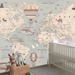 World map wallpaper in a nursery with a crib and toys.