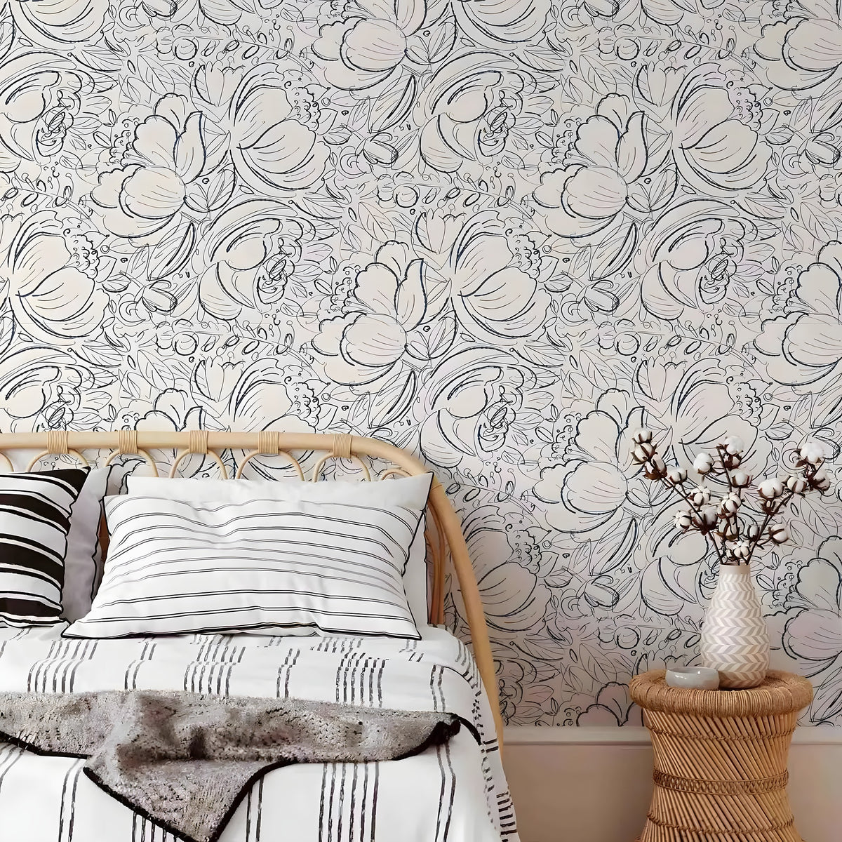 Bedroom with floral wallpaper, bed, and side table.