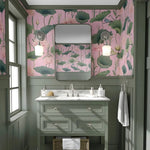 Bathroom with pink floral wallpaper, green vanity, and white sink.