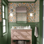 Bathroom with floral wallpaper, wooden vanity, and decorative elements.