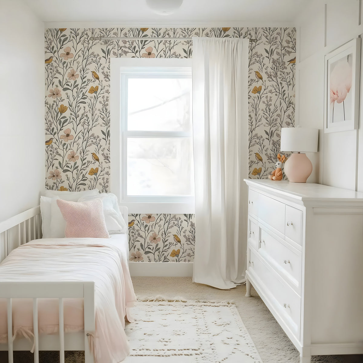 Children's bedroom with floral wallpaper, white furniture, and pink accents.