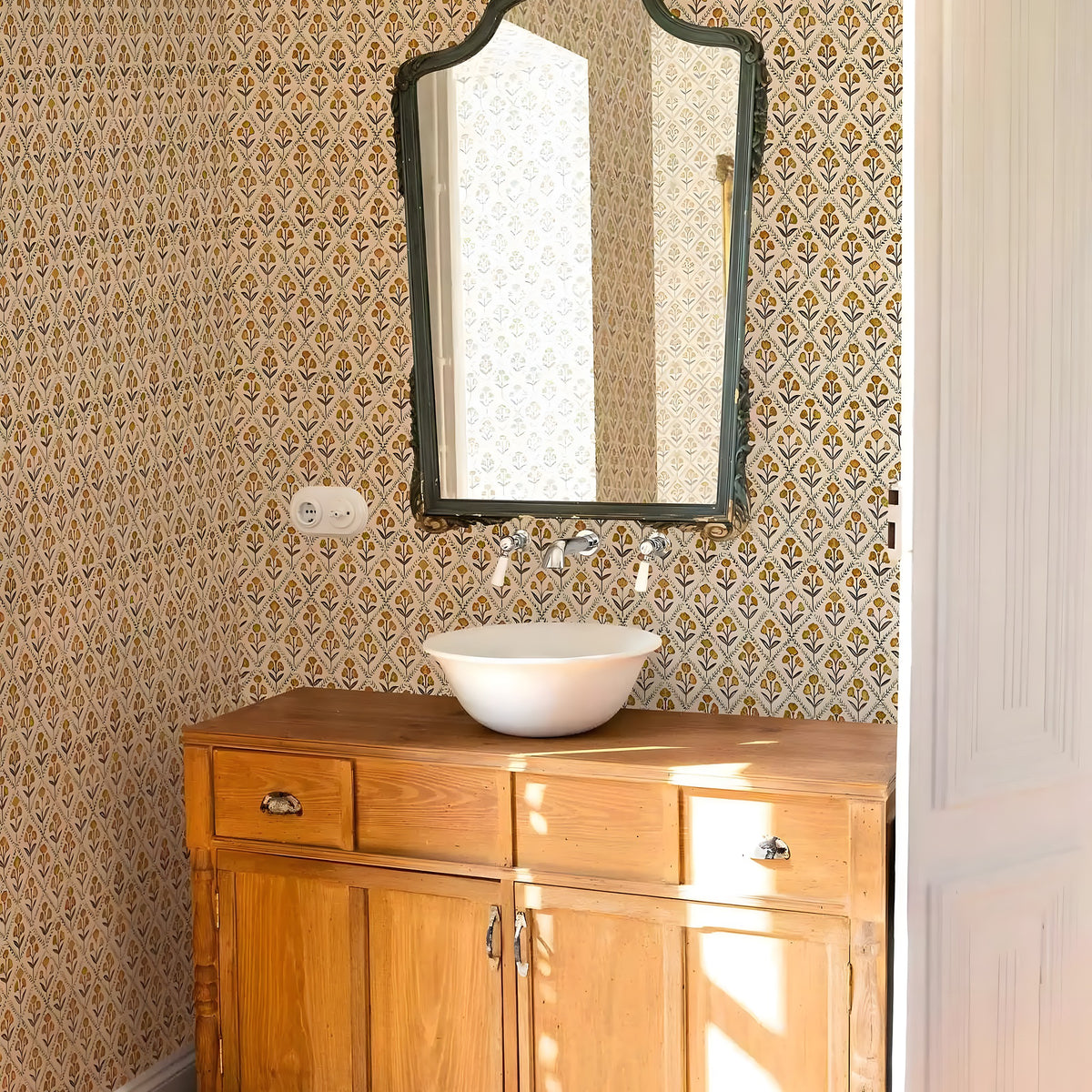 Wooden vanity with a mirror against patterned wallpaper