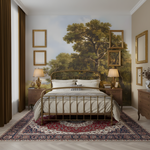 Luxurious bedroom with a large wall mural of trees and framed landscapes.