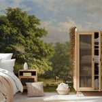 Room interior with wooden wardrobe, bed, and side table against a scenic wall mural.