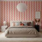 Modern bedroom with a bed against a wall featuring red and white wavy pattern.