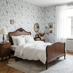 Vintage bedroom with wooden bed, floral wallpaper, and wooden nightstands.