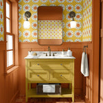 Bathroom with yellow vanity, floral wallpaper, and wooden floor.