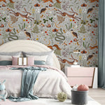 Bedroom with floral and animal-themed wallpaper, bed with pink bedding, and decorative items.
