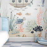 Children's room with an underwater-themed wall mural featuring sea creatures and plants.