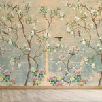 Decorative wallpaper with floral and bird designs on a textured wall.