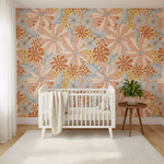 Nursery room with floral wallpaper, white crib, and small table with plant.