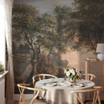 Dining room with a large wall mural of a forest scene, round table with place settings, and chairs.