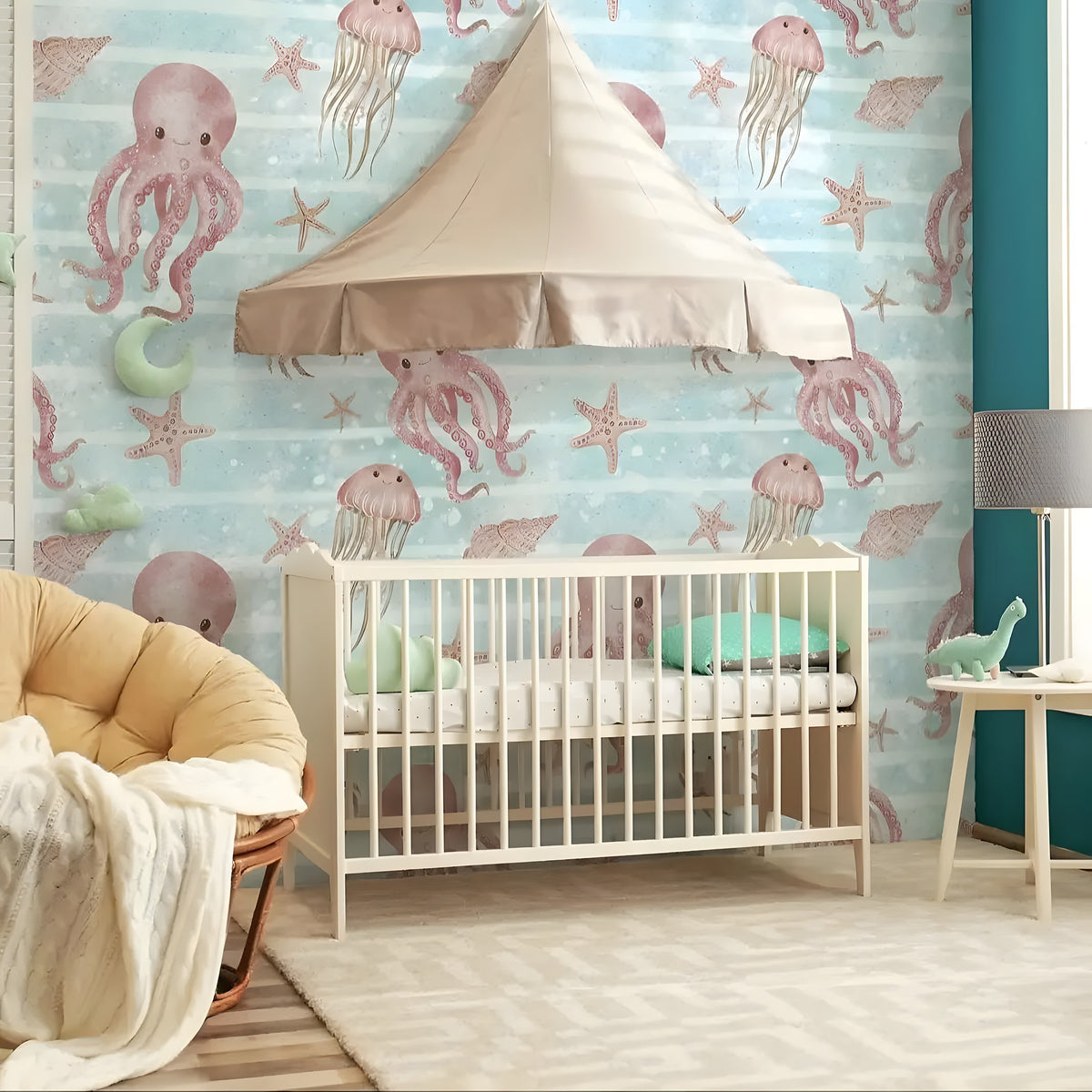 Children's room with crib, colorful wallpaper featuring sea creatures, and a lamp.