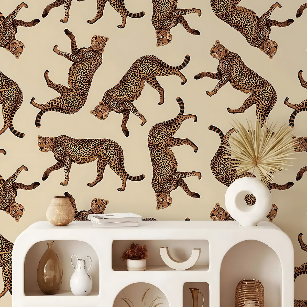 Decorative wall with cheetah pattern above a white console table with decorative items.