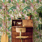 Wooden desk with chair against a tropical floral wallpaper background