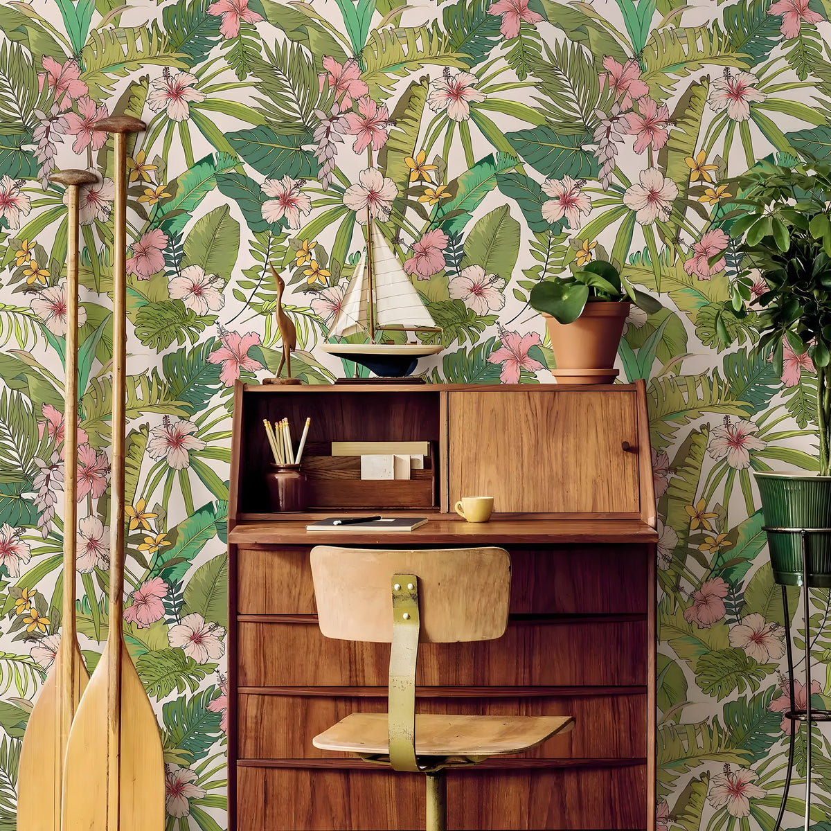 Wooden desk with chair against a tropical floral wallpaper background