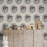 Wooden shelf with toys against a wallpapered wall with animal patterns