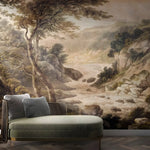 Green sofa in front of a wall mural depicting a landscape with trees and rocks.