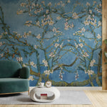 Living room with teal armchair and coffee table in front of a Van Gogh-style wall mural.