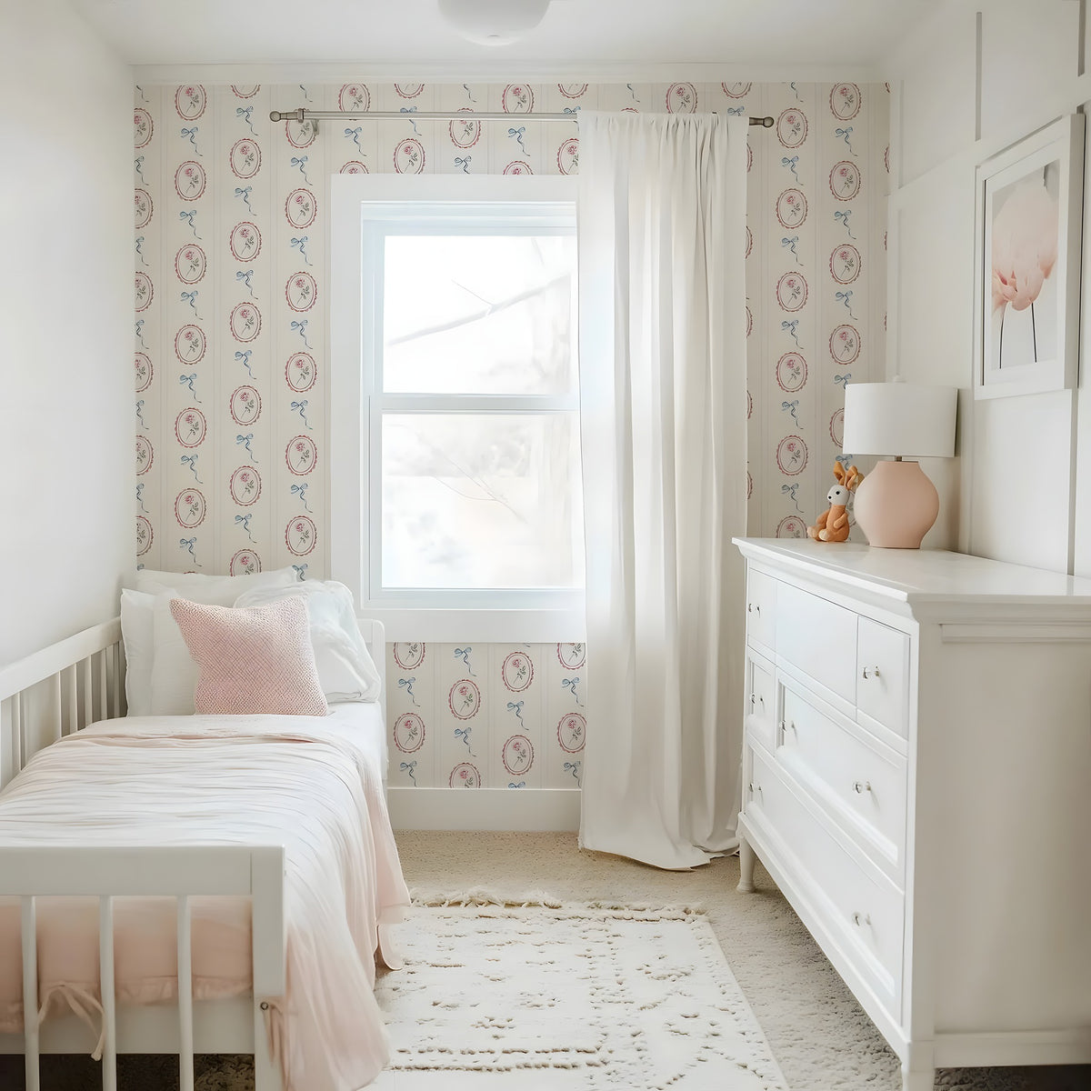 Children's bedroom with pink and white theme, including a bed, dresser, and decorative elements.
