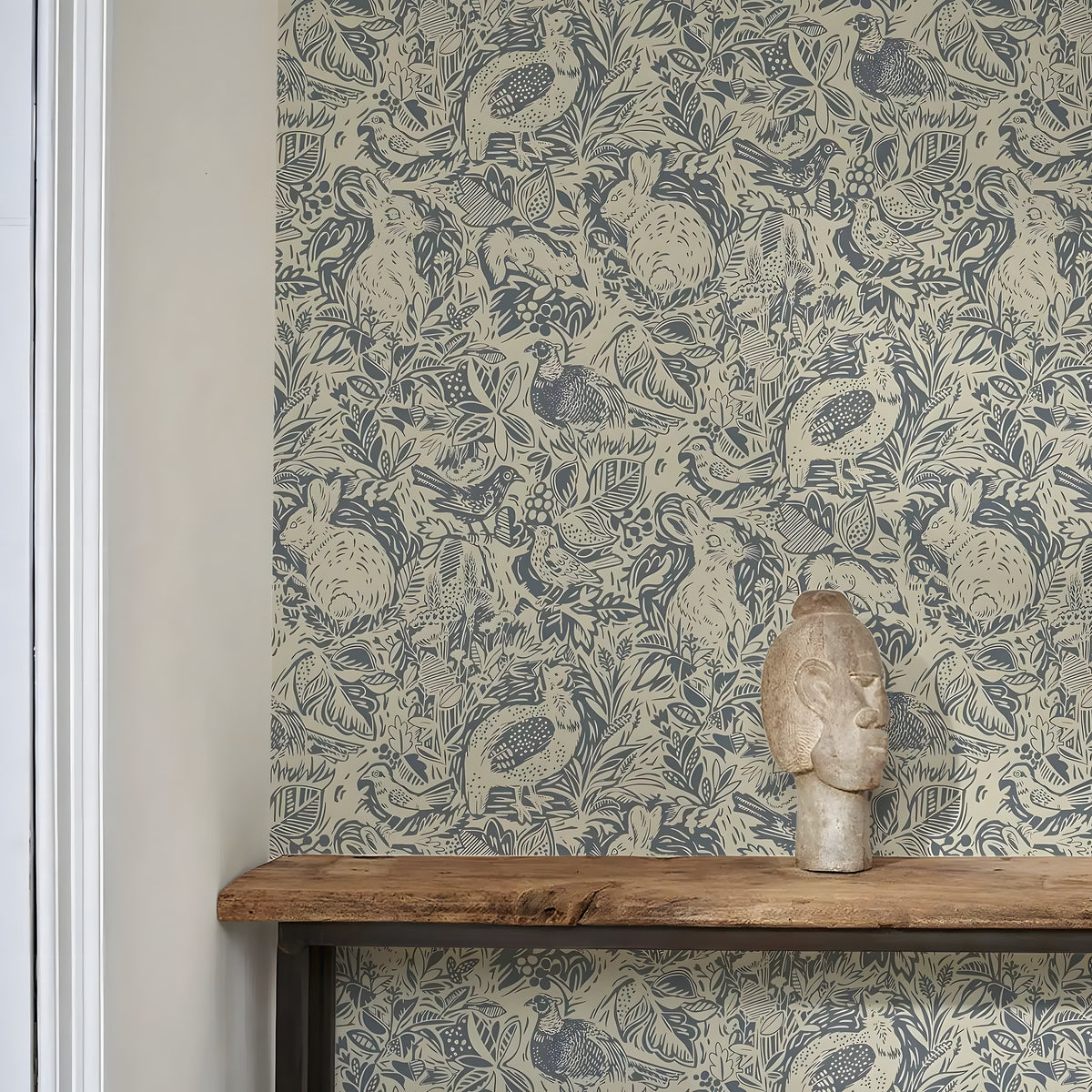 Wallpaper with nature-themed design featuring birds and foliage, wooden shelf with decorative item below.