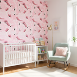 Nursery room with pink flamingo wallpaper, white crib, and rocking chair.