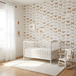 Nursery room with white crib and rocking chair against a butterfly-patterned wall.