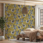 Room interior with a wall featuring a bird pattern on a yellow background.