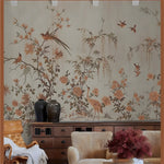 Living room with floral wallpaper featuring birds and plants, a wooden cabinet, and armchair.