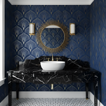 Bathroom with blue patterned wallpaper, black marble vanity, and white sink.