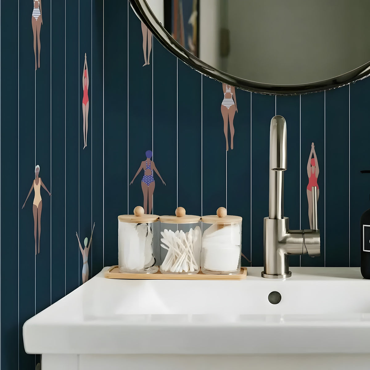 Bathroom sink with decorative items against a wall with vertical line pattern and small figures.