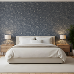 Modern bedroom with a bed, nightstands, and decorative wall paper.