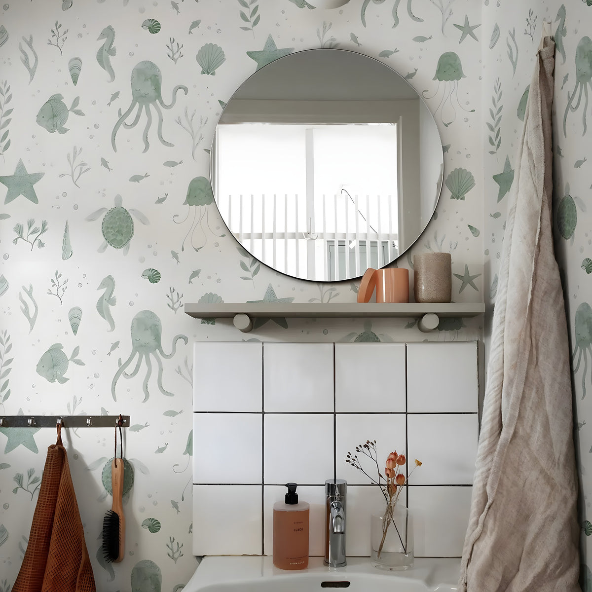 Bathroom with green underwater-themed wallpaper, round mirror, and sink.