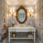 Luxurious bathroom with ornate mirror, marble sink, and decorative walls.