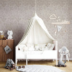 Children's bedroom with a white canopy bed, toys, and decorative elements.