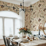 Dining room with floral wallpaper, table set for a meal, and decorative elements.