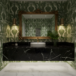 Bathroom with green patterned wallpaper, black marble vanity, and gold-framed mirror.
