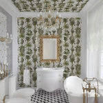 Luxurious bathroom with palm tree wallpaper, gold fixtures, and a chandelier.
