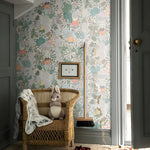 Children's room with floral wallpaper, wicker chair, and decorative elements.