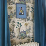 Framed portrait on a wall with decorative wallpaper and blue curtains